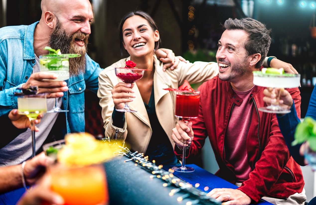 Hosting a cocktail party - A group of friends enjoying their colorful cocktails during a private party.