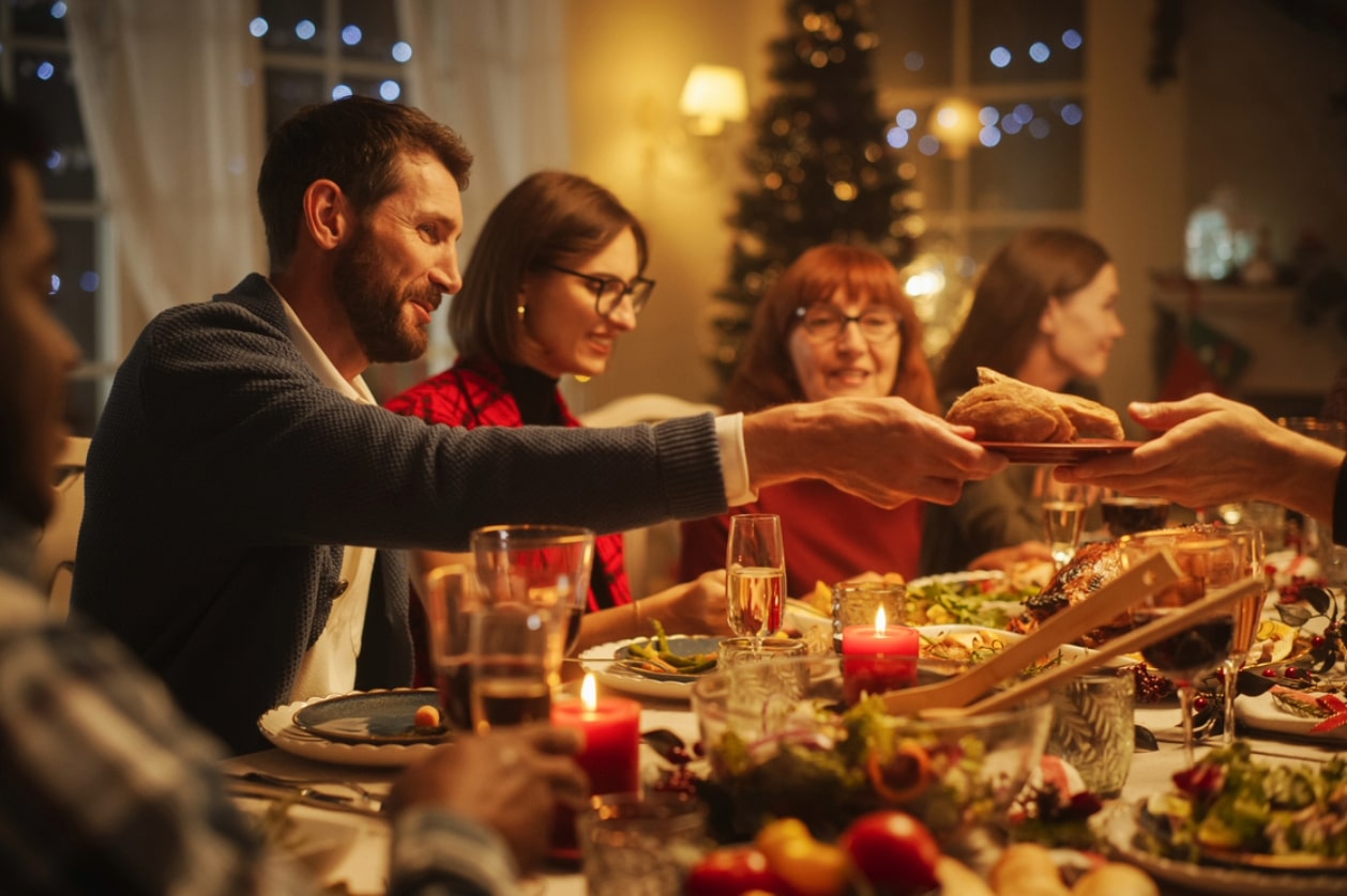 Creating warm holiday gatherings - A family enjoying a holiday dinner in a cozy home.